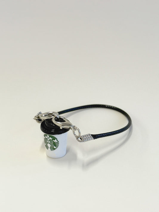Starbucks cup-shaped keychain with black band on a white background
Labubu accessories
Labubu Starbucks accessories